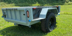 Grey Slack Wagon trailer, rear three-quarter view on grass