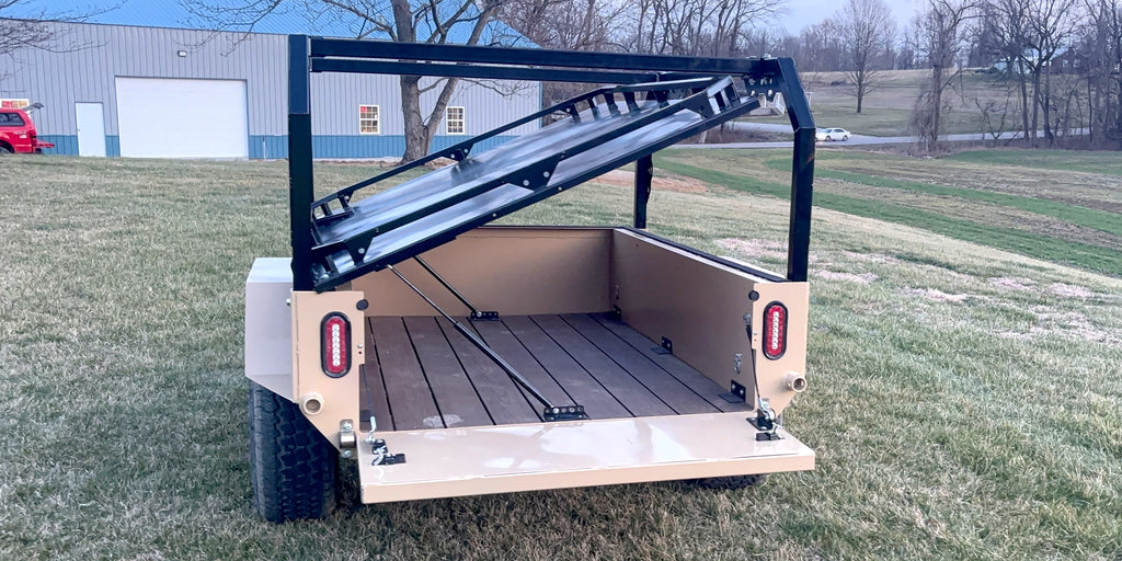 Tan Slack Wagon with tailgate down showing the deck boards and a tilted rack