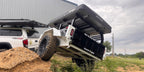 Slack Wagon trailer articulating over a dirt mound behind a Toyota Tacoma