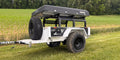 White Big Slack Off Road Slack Wagon trailer with rooftop tent and spare tire, front three-quarter view