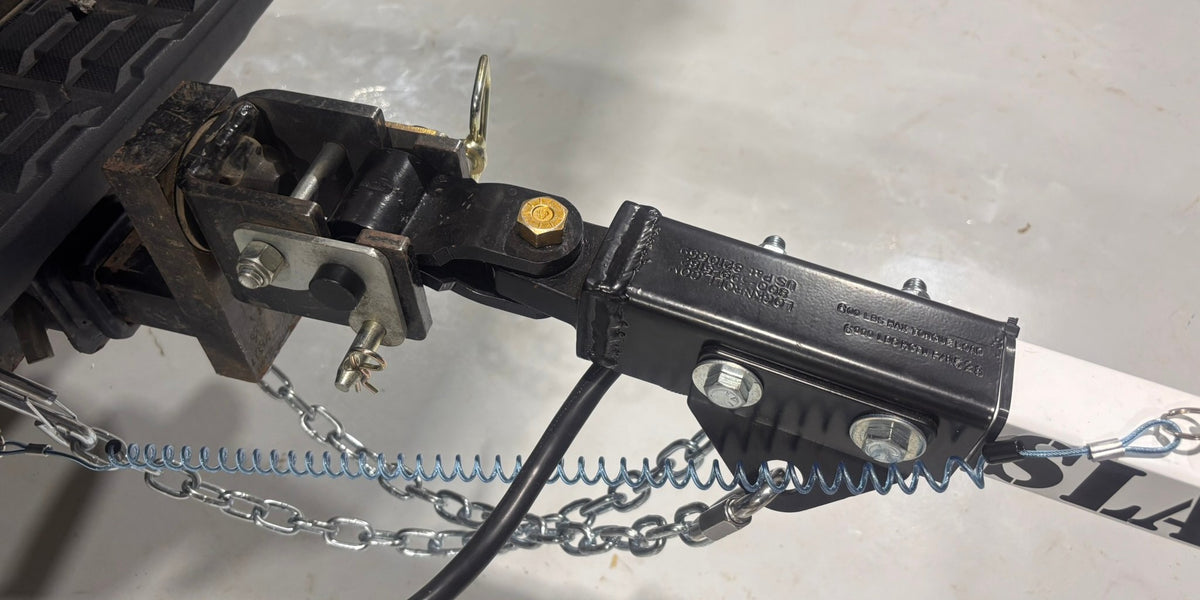 Articulating hitch on the Slack Wagon tongue with safety chains